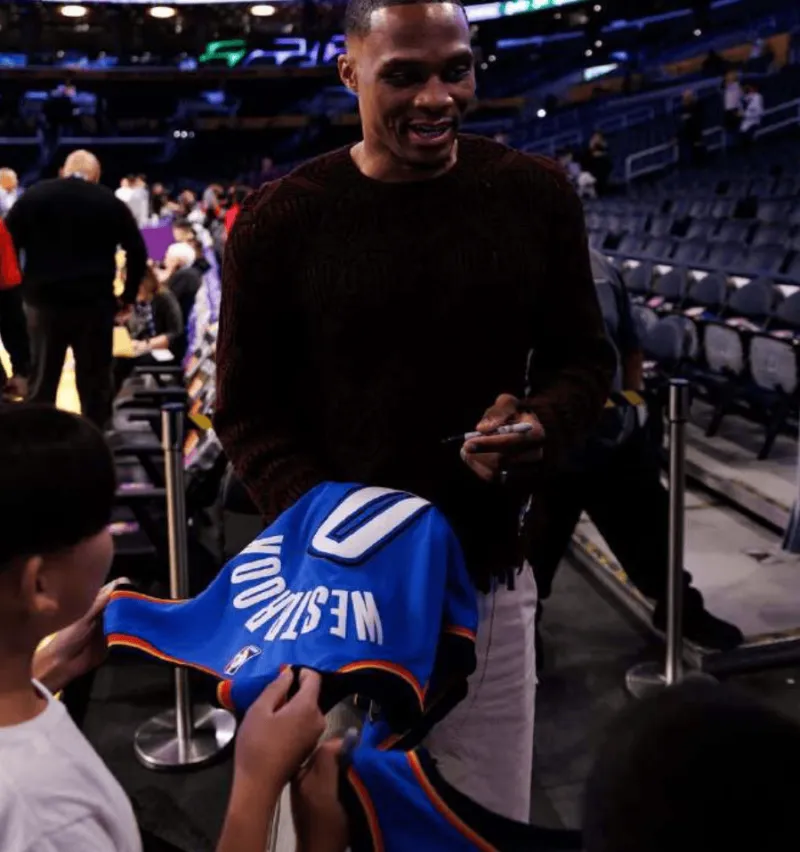 Westbrook posted a photo of himself signing autographs for a young fan on social media with the caption: Only love!