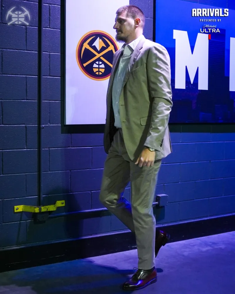 The Nuggets players entered their home arena, with Jokic standing out in a suit.