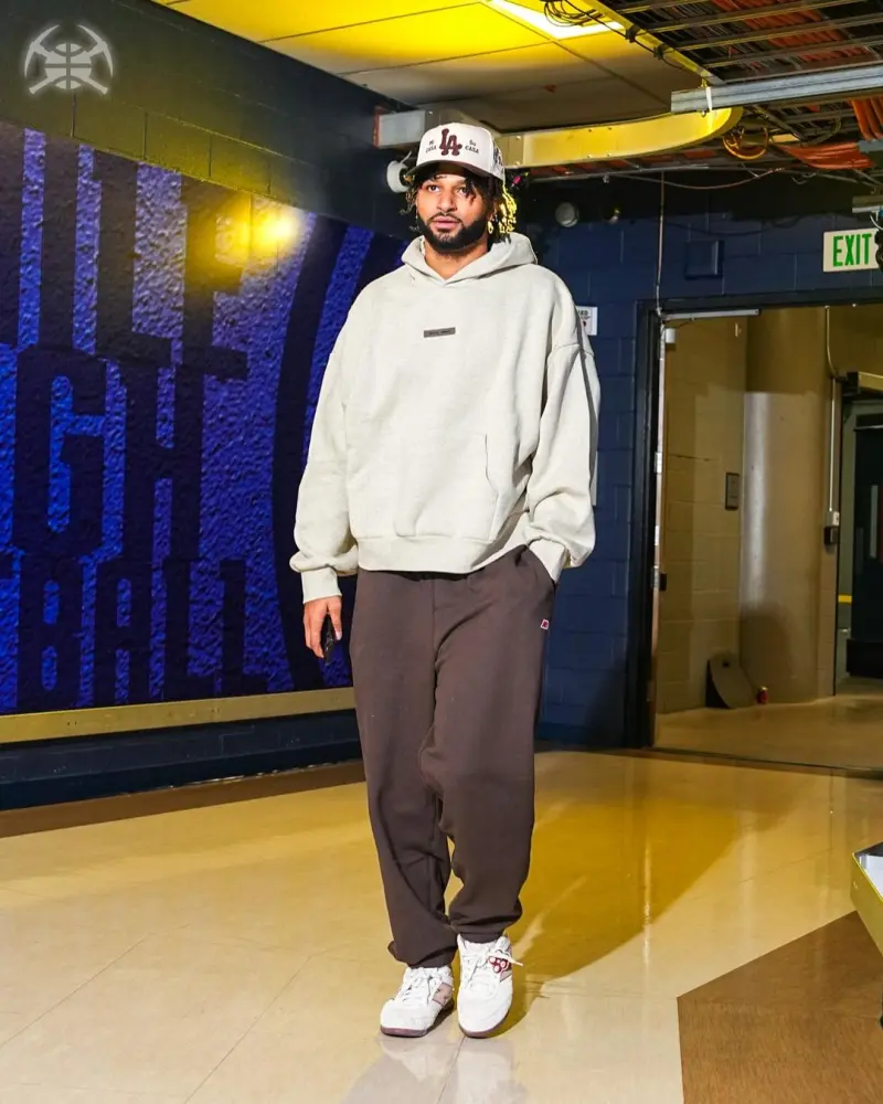 The Nuggets players entered their home arena, with Jokic standing out in a suit.