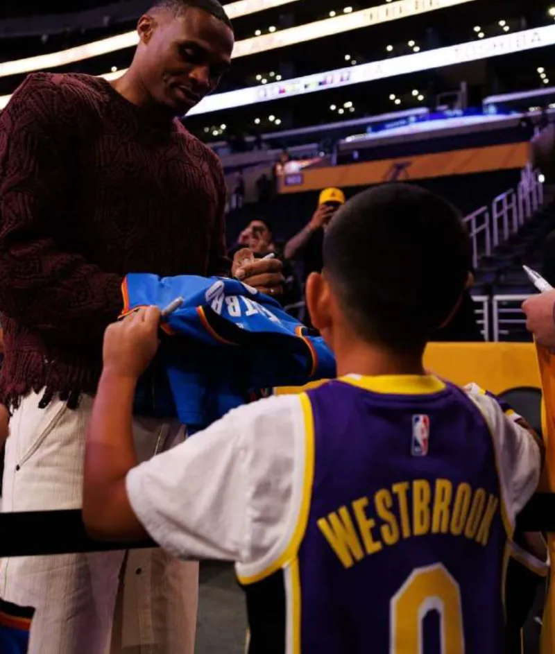 Westbrook posted a photo of himself signing autographs for a young fan on social media with the caption: Only love!