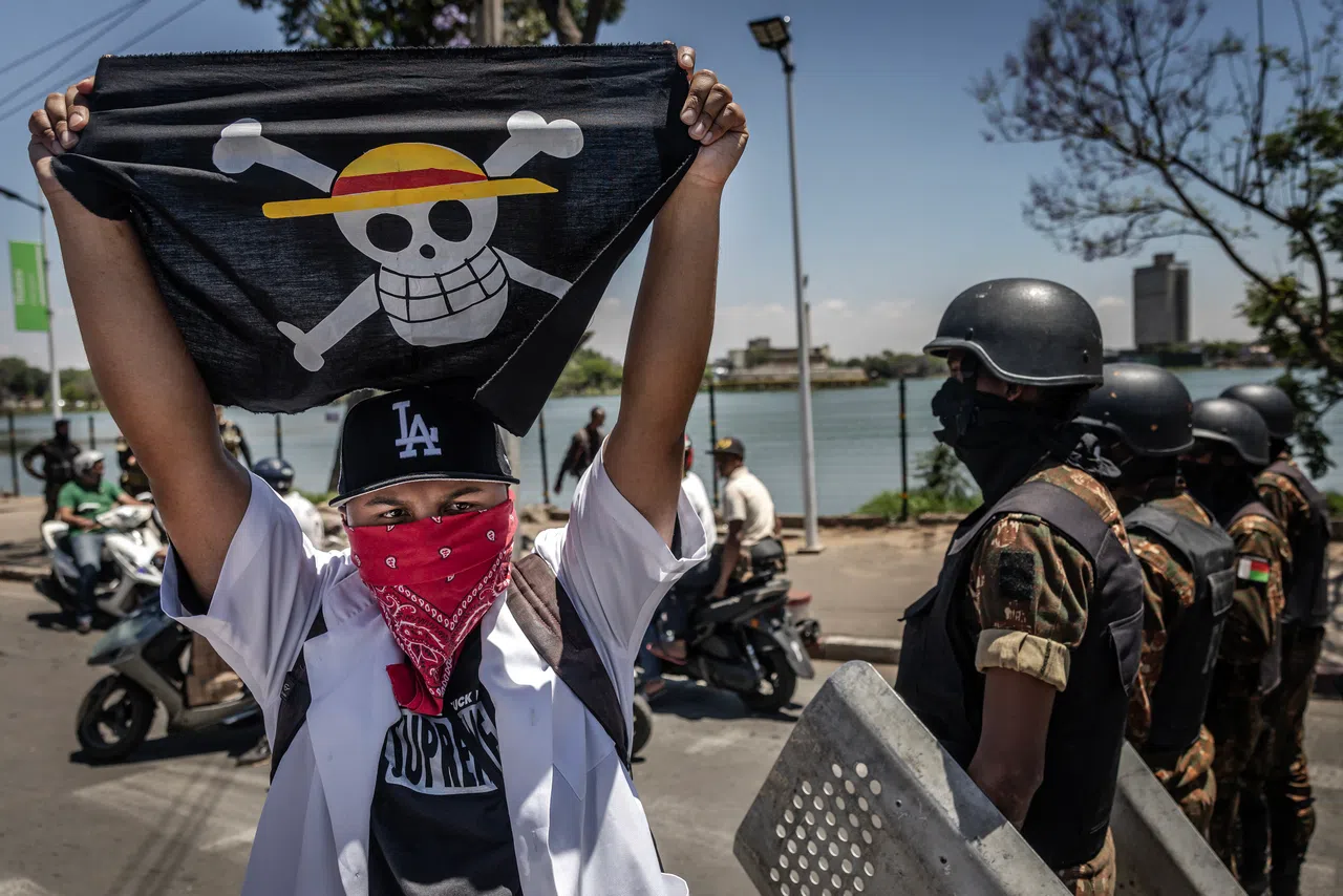 Gen Z youths taking to the streets to protest while waving pirate flags