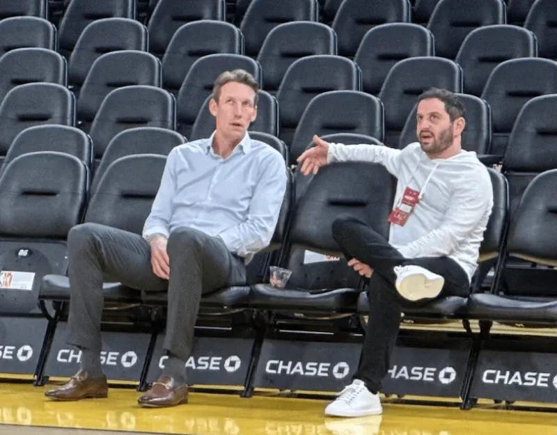 What were they talking about? Warriors general manager Mike Dunleavy and Cuminga's agent were discussing things courtside before the game.
